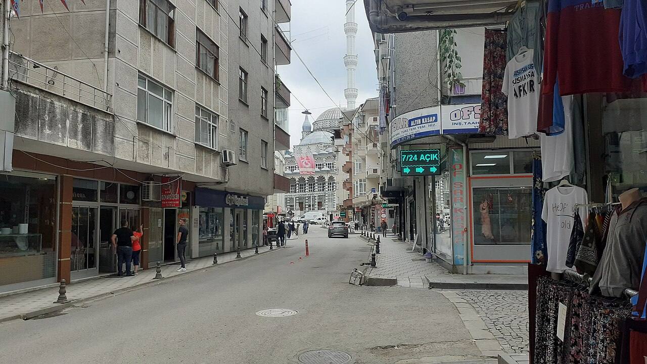 Shops along a street in Of town centre, with a mosque in the background